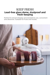Close-up of a clear lead-free glass dome with a solid acacia wood base for dessert display