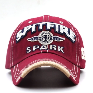 Close-up of SPARK letter embroidery and vintage contrast stitching on a cotton baseball cap