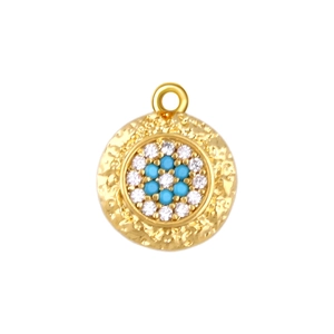 Detail of gold evil eye pendant with blue zircon stones and hammered texture finish