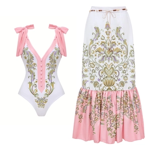 Close-up of V-neck swimsuit with floral prints and ruffle skirt with shell belt