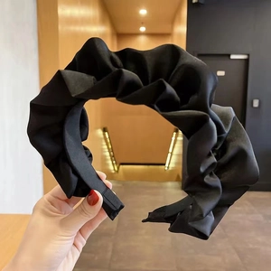 Fashionable black pleated fabric headband with a stylish puffed design for high top hair