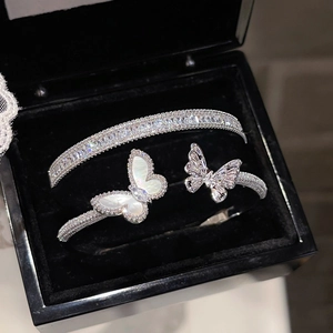 Close-up of silver butterfly bracelet with mother of pearl and sparkling zircon details