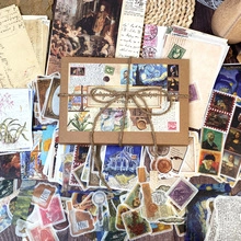 Flat lay of vintage scrapbooking material kit featuring classic art and retro paper motifs