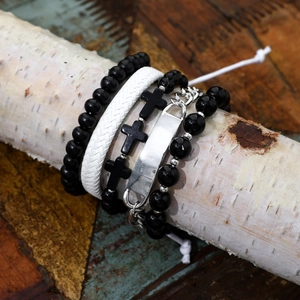 Men's hip-hop multi-layer bracelet set with black beads and silver cross charms on wood