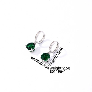 Detail view of silver earrings with green zircon drops and micro-pave crystals