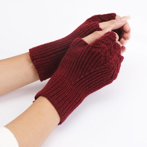 Detailed knit texture of burgundy fingerless gloves with a stylish cable pattern