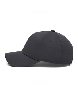 Side view of a dark grey cotton twill baseball cap with curved brim and eyelets