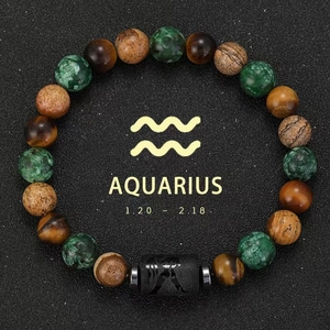 Aquarius zodiac bracelet with tiger eye and agate beads on black sand background
