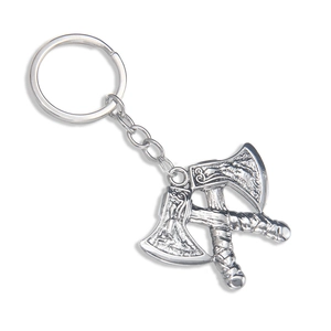 Silver metal Viking double axe keychain with detailed embossed patterns on white background