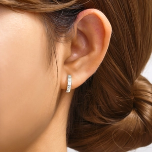 Close-up of S925 sterling silver hoop earring with three round sparkling zircon stones