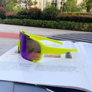 Detail of neon yellow sports sunglasses with purple polarized lens on a lifestyle background