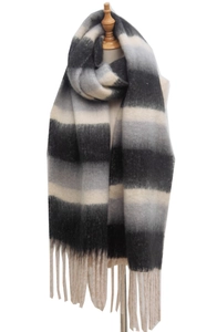 Detail of thick striped scarf with tassels and chunky yarn texture in black and beige
