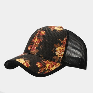 Detail of floral straw trucker hat showing black mesh back and rose print on the brim