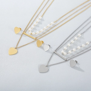 Layered stainless steel jewelry set with heart pendants and pearls in gold and silver