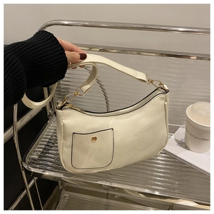Detail view of white vintage square hobo bag with gold hardware and snap pocket