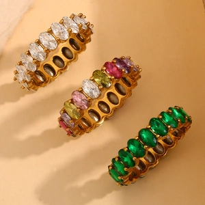 Macro view of gold rings with oval white, green and multicolor stones set in gold