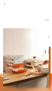 Double-layer drawer style egg storage box in a modern kitchen setting with white and orange frames