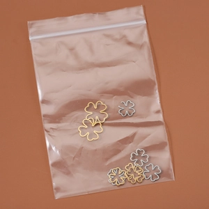 Mixed gold and silver 18k plated stainless steel clover pendants in clear packaging