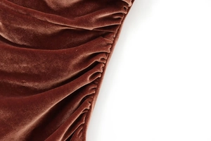 Detailed view of the brown velvet fabric showing pleated texture and glossy finish