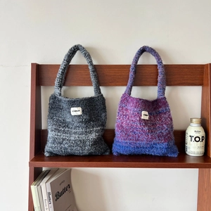 Detailed knit texture of gradient purple and grey shoulder bags with STANNUM label