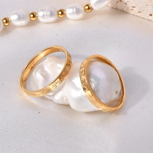 Polished 18k gold plated stainless steel rings with sunburst pattern on baroque pearl