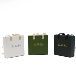 Elegant jewelry gift boxes with ribbon handles in white, dark green, and black colors