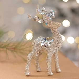 Sparkling gold reindeer Christmas ornament with silver sequins and warm bokeh background