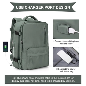 Detail view of large green travel backpack showing integrated USB charging port and phone usage