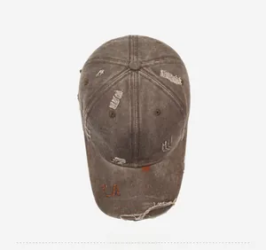 Detail of vintage washed baseball cap featuring distressed holes and Black Palm embroidery