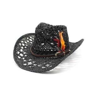 Black hollow-out straw cowboy hat with thin leather band and colorful feather accent