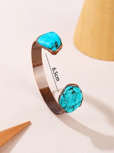 Detail shot of vintage bronze cuff with turquoise inlay and 6.5cm diameter measurement
