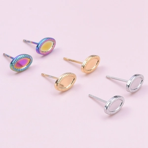 Oval stainless steel earrings in rainbow, gold, and silver with knurled textured edges