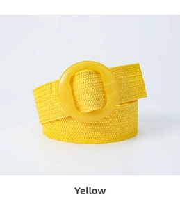 Close-up of bohemian yellow straw woven elastic belt with matching round resin buckle
