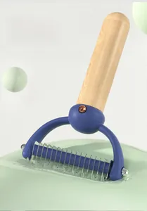Close-up of curved stainless steel blades and safety tips on the pet grooming rake