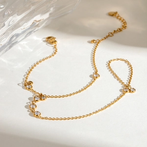 Detailed shot of gold ring bracelet with sparkling round zircons and delicate water reflections
