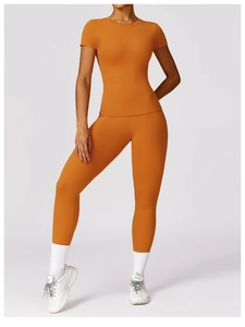 Detail of moisture-wicking amber yoga set featuring short-sleeve top and high-waist leggings