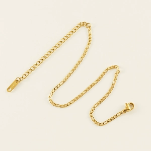Polished gold stainless steel Figaro chain anklet with lobster clasp on beige background