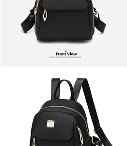 Close-up of black waterproof nylon backpack featuring gold zippers and logo plaque