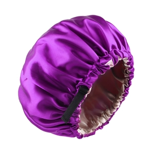 Detail view of double-layered satin bonnet in purple and champagne with adjustable strap