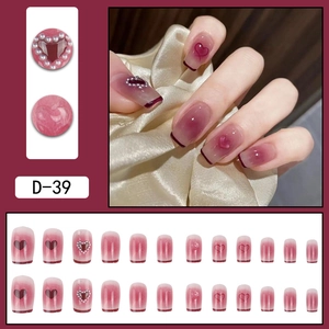 Pink gradient French press-on nails with pearl hearts and red borders in a 3-grid display