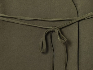 Macro shot of olive green woven fabric showing twill texture and tied bow detail