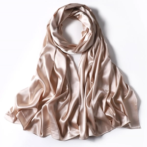 Detailed close-up showing the smooth champagne satin texture of the elegant silk scarf