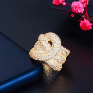 Macro shot of gold knotted ring featuring AAA cubic zirconia micro-pave detailing
