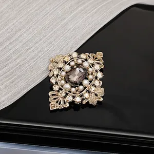 Close-up of Style E vintage baroque brooch with brown gemstone and micro-set pearls