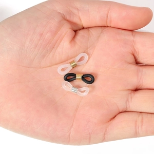Silicone anti-slip eyeglass chain connectors with metal coils held in hand for scale