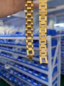Close-up of gold stainless steel watch band bracelets in President and Oyster styles