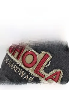Detailed close-up of 3D HOLA embroidery on distressed grey washed cotton baseball cap