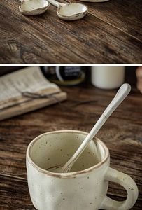Macro shot of handmade beige ceramic mug and spoons with vintage grainy texture