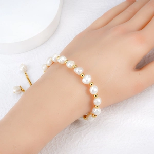 Elegant freshwater pearl bracelet with gold spacer beads and adjustable chain on wrist