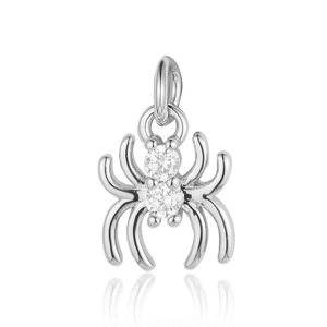 Macro detail of a silver spider pendant with clear cubic zirconia stones on white background